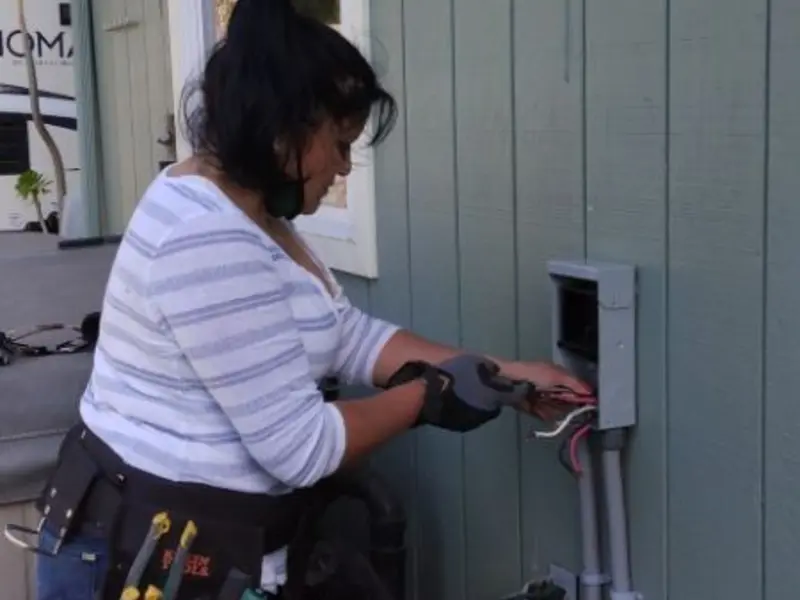 Licensed electrician wiring an exterior subpanel in Monett