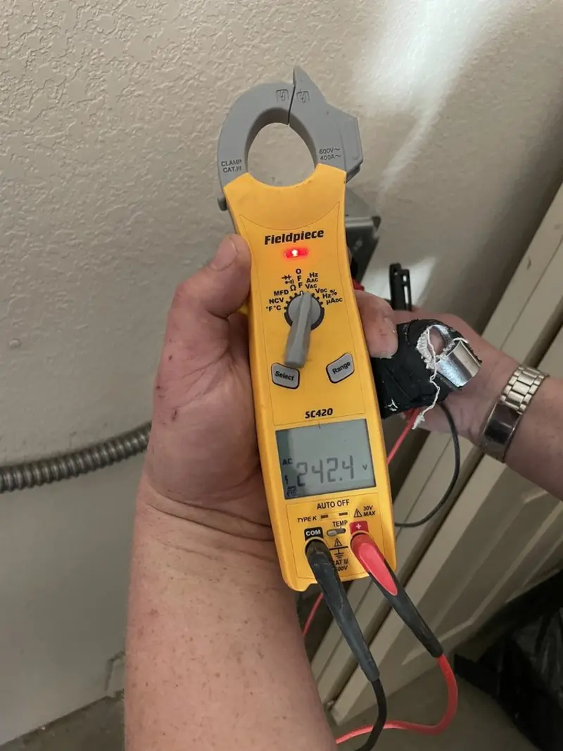 Voltage testing with clamp meter during Electrical Installation Services in Monett